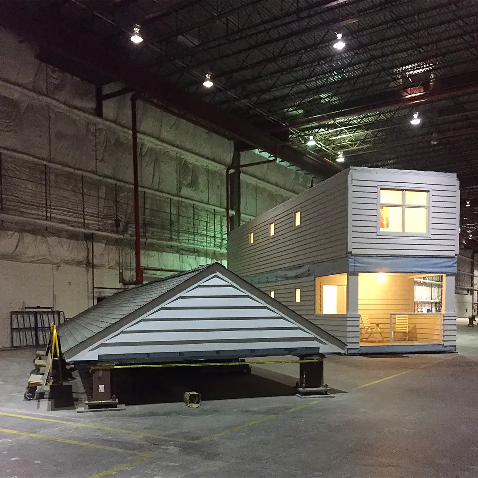 A crane lifting a factory-built home module